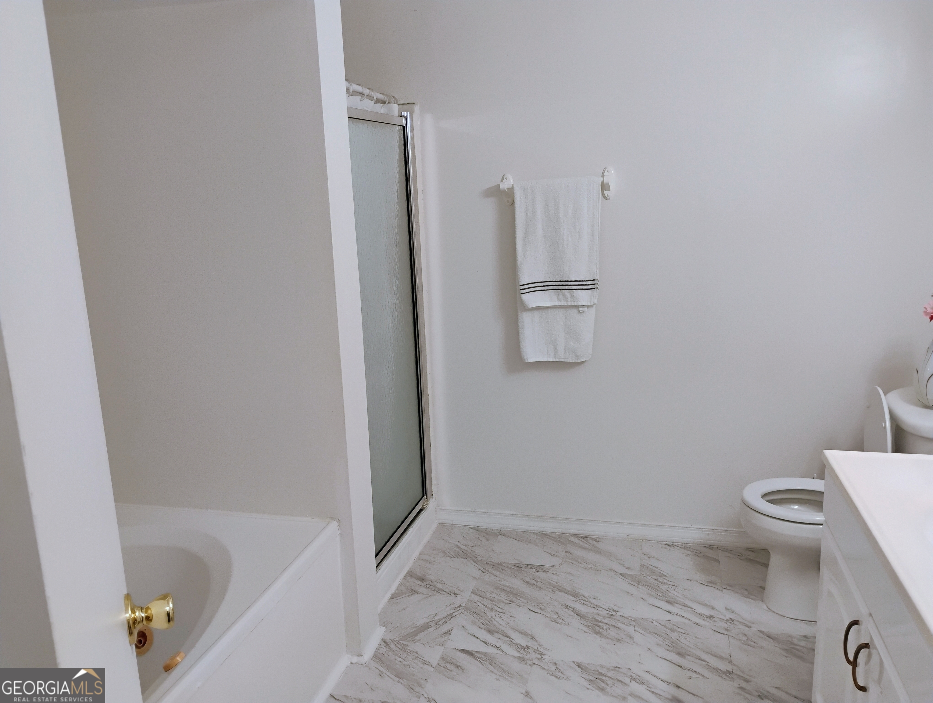 6501 River Run Road Riverdale, GA 30274 - Photo 12 of 18 a bathroom with a toilet and a tub