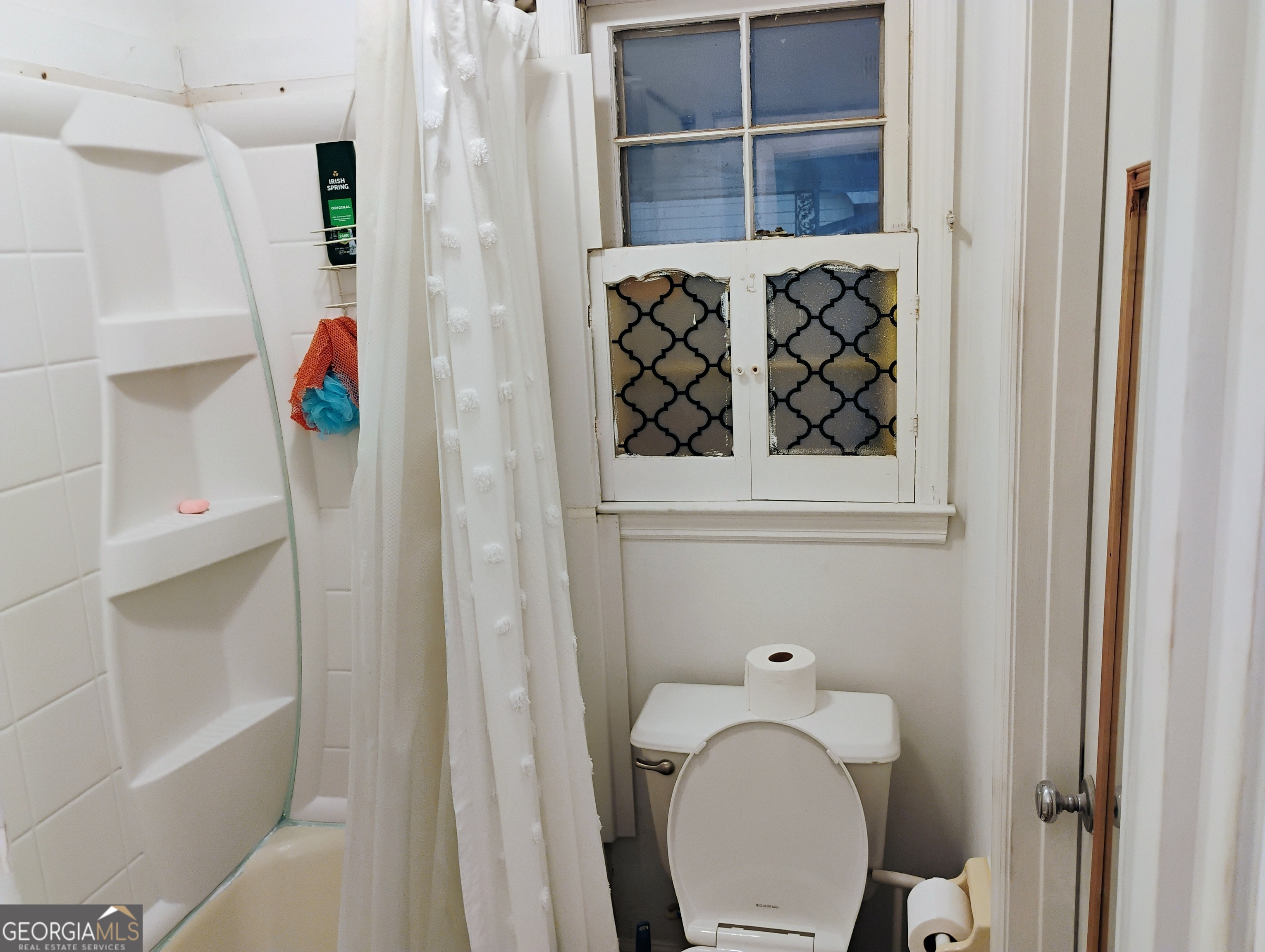 6501 River Run Road Riverdale, GA 30274 - Photo 15 of 18 a bathroom with a toilet and a shower curtain