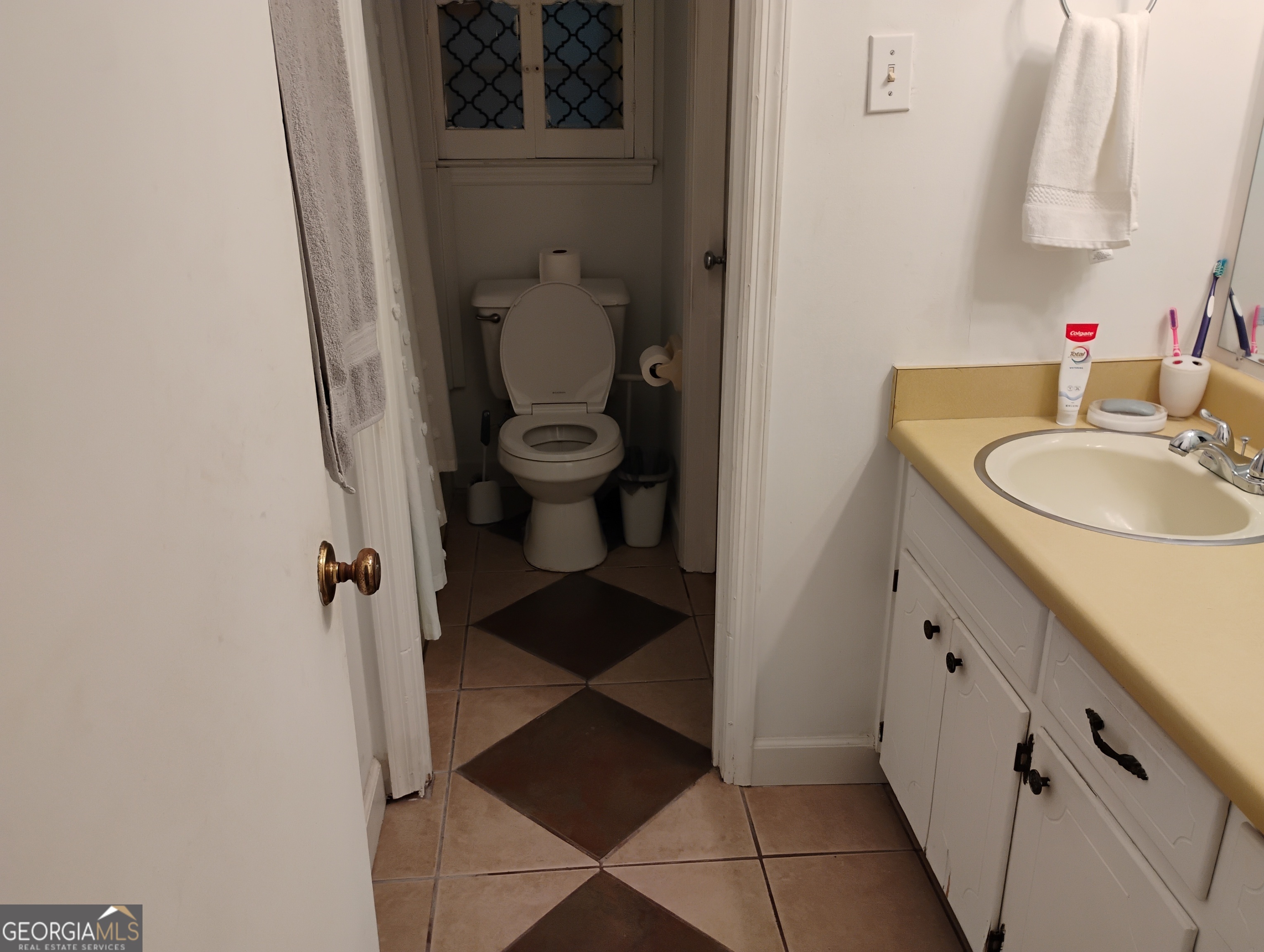 6501 River Run Road Riverdale, GA 30274 - Photo 16 of 18 a bathroom with a sink and a mirror