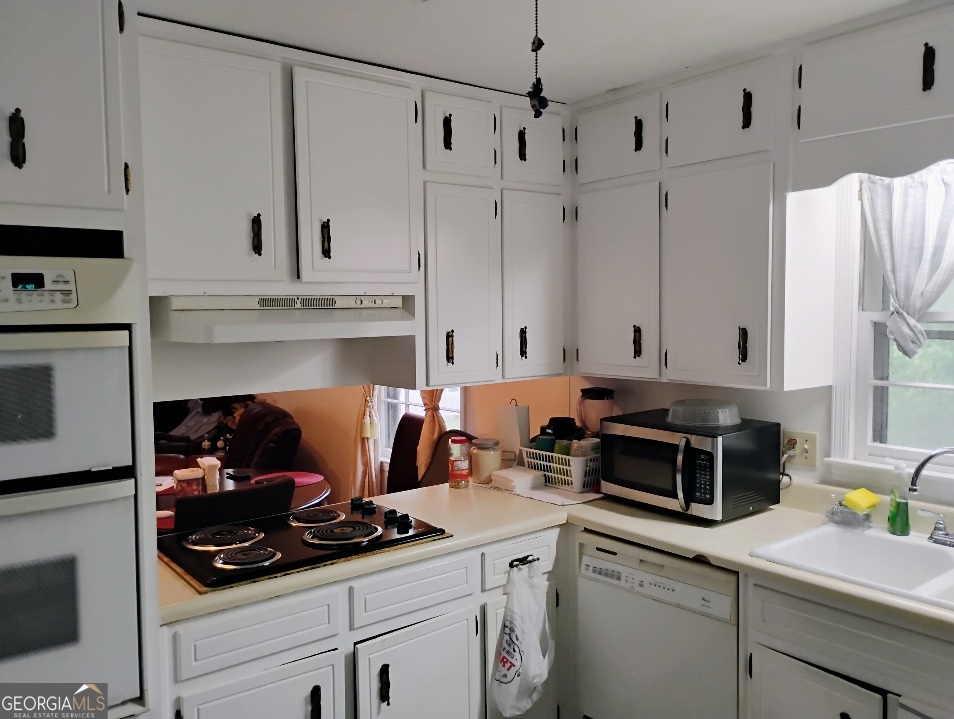 6501 River Run Road Riverdale, GA 30274 - Photo 5 of 18 a kitchen with stainless steel appliances white cabinets and a stove