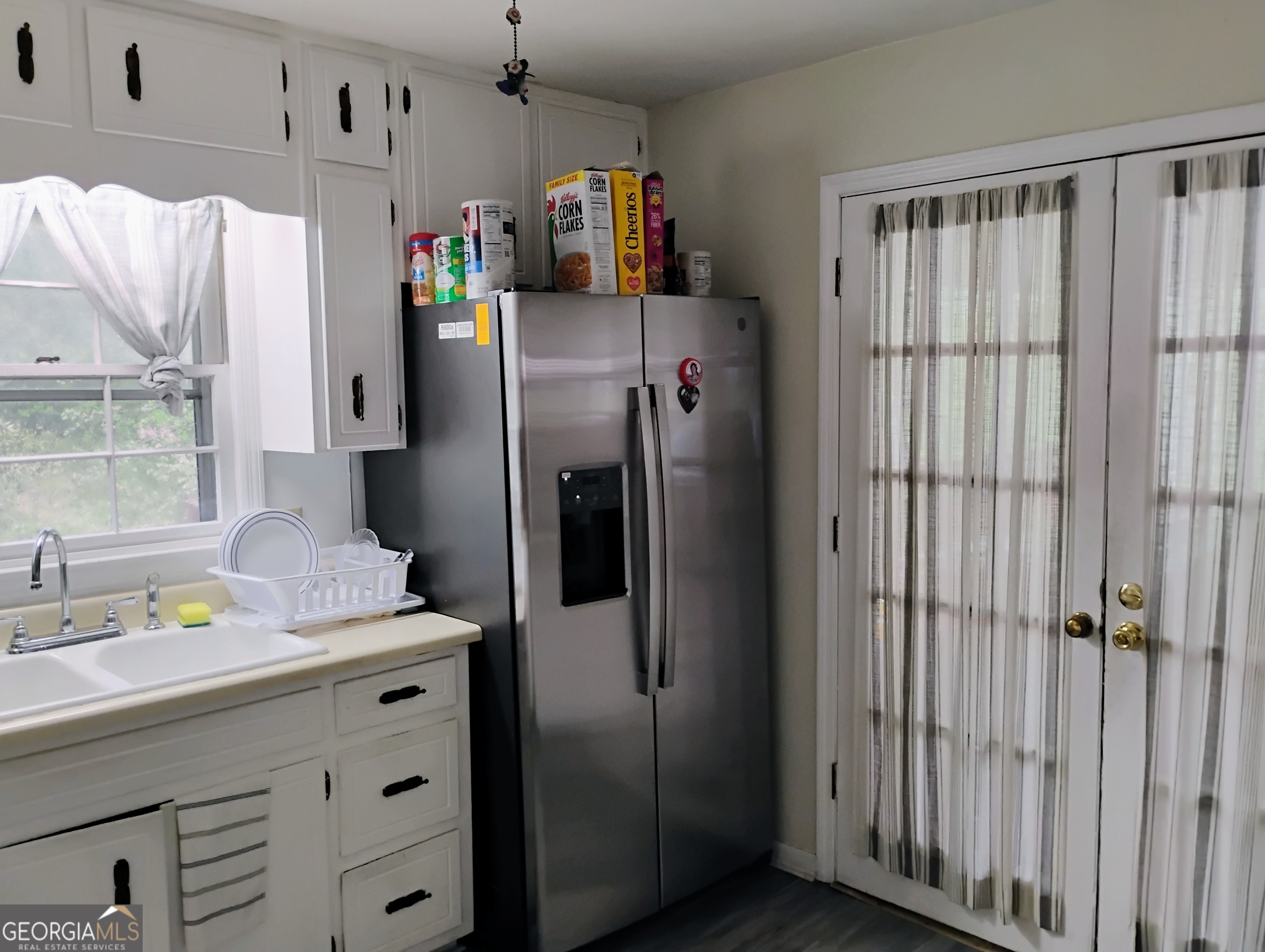 6501 River Run Road Riverdale, GA 30274 - Photo 6 of 18 a kitchen with stainless steel appliances a refrigerator and a window