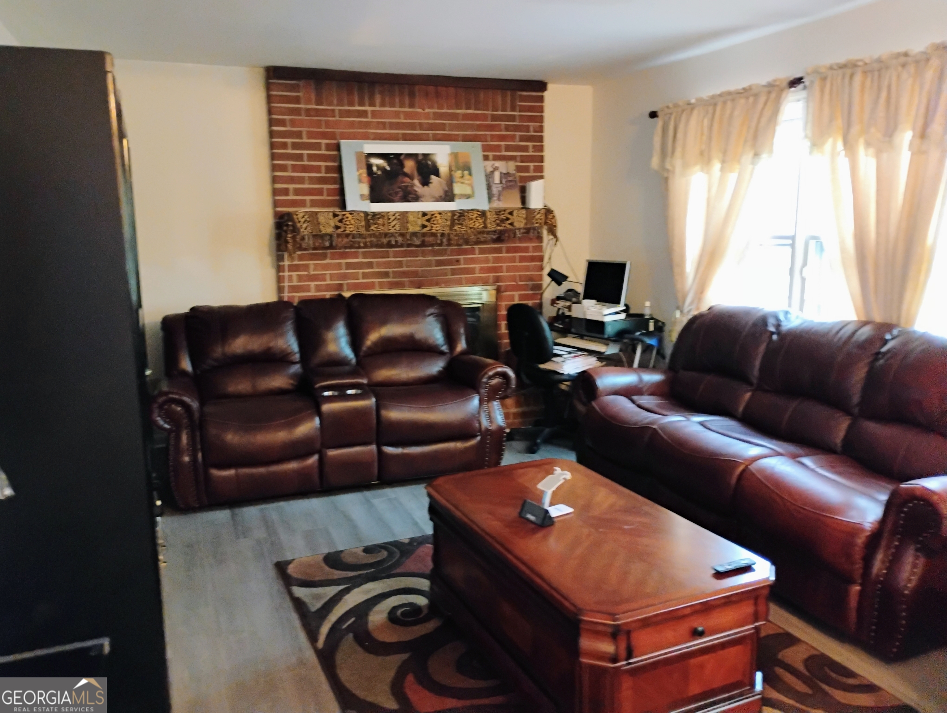 6501 River Run Road Riverdale, GA 30274 - Photo 7 of 18 a living room with furniture and a fireplace