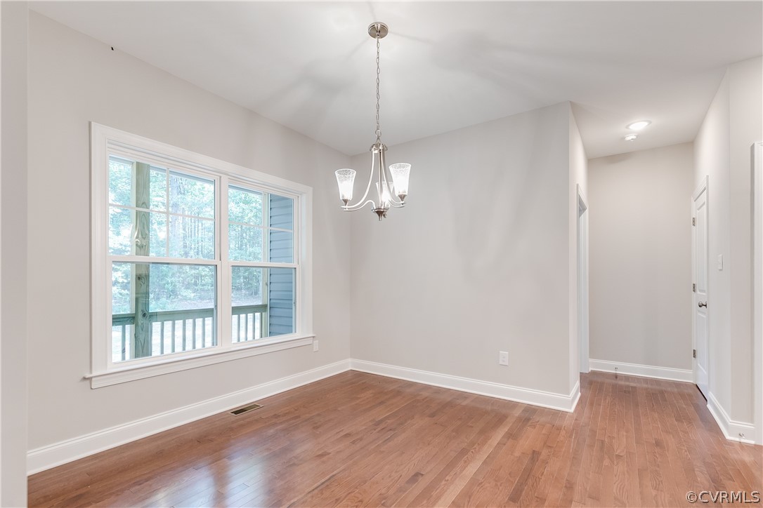 3663 West Rocketts Ridge Road Goochland, VA 23063 - Photo 8 of 33 a view of a room with wooden floor ceiling fan and window