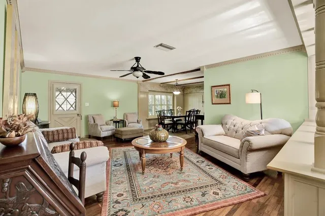 a living room with furniture and a chandelier