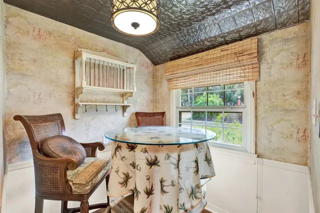 a dining room with furniture and wooden floor