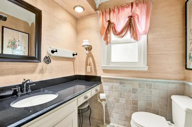 a bathroom with a sink a mirror and a toilet