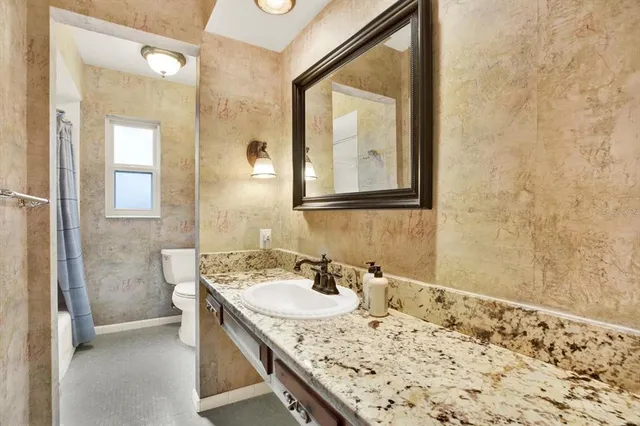 a bathroom with a sink vanity and a mirror