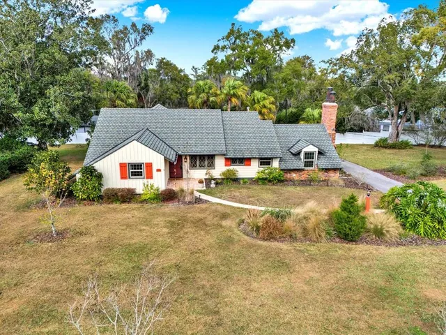 a view of house with garden space and swimming pool