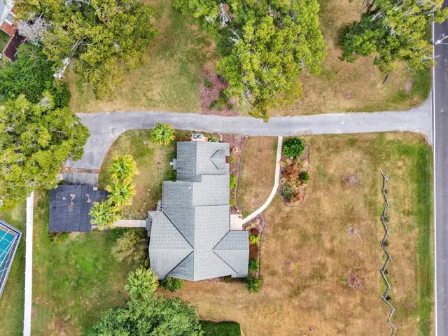 an aerial view of a house with a yard and lake view