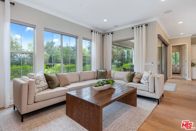 a view of hallway with a large window and wooden floor