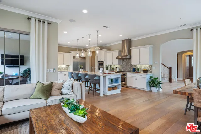a bedroom with a bed a dresser and next to a window