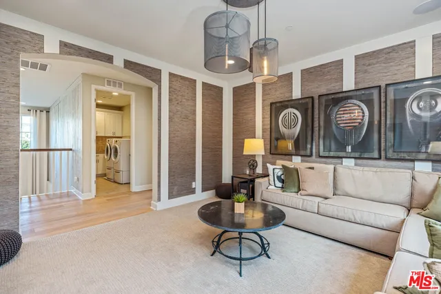 a spacious bedroom with a bed couch table and a large window