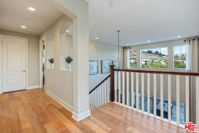 a living room with furniture a flat screen tv and a floor to ceiling window
