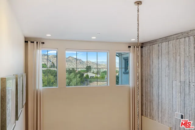 a living room with furniture fireplace and a large window