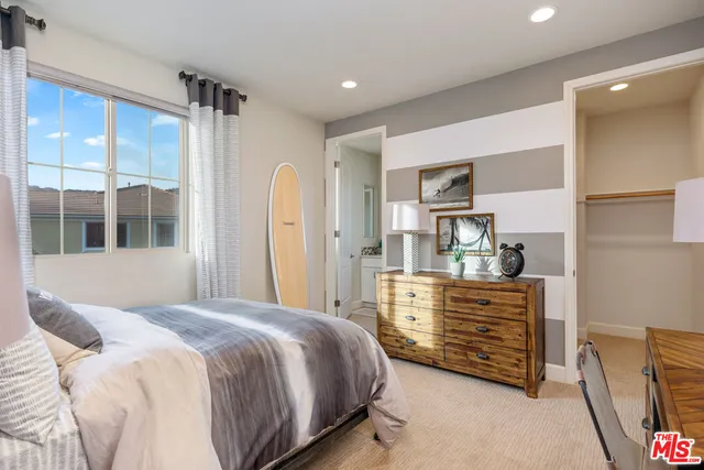 a white bath tub sitting in a bathroom and mirror