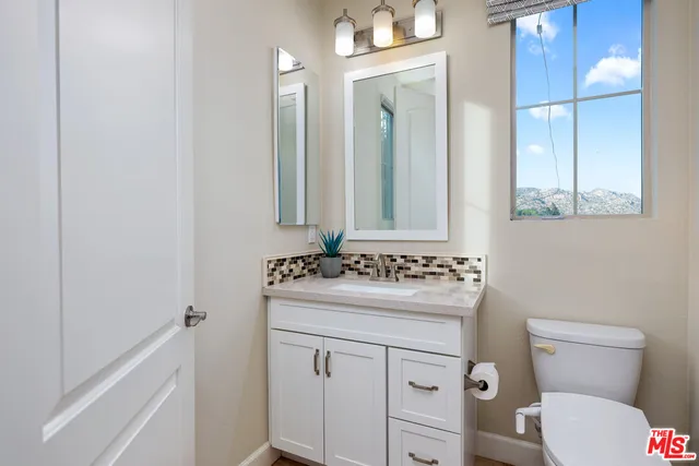 walk in closet with white walls