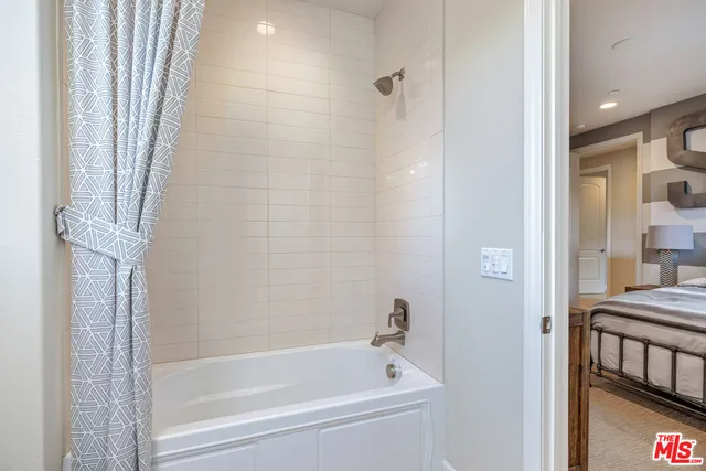a dining room with furniture and a floor to ceiling window
