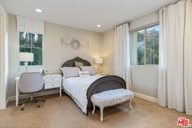 a view of a backyard with swimming pool and trees