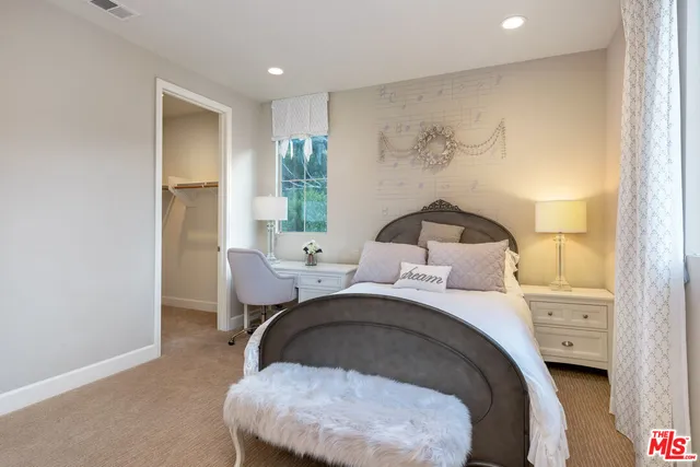 a view of a chair and table in backyard of the house