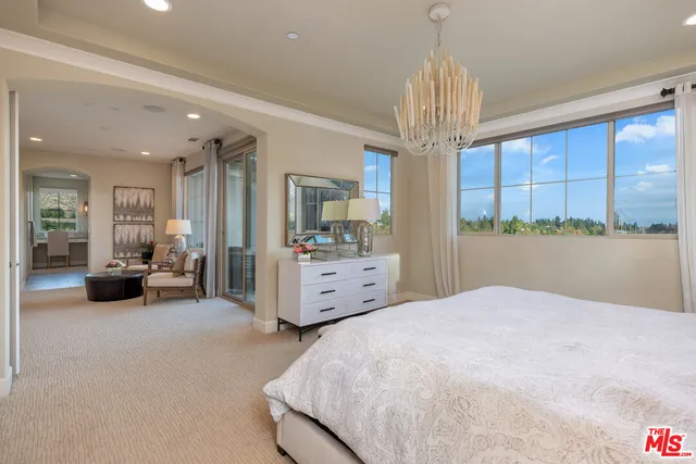 a view of a white house with a yard and potted plants