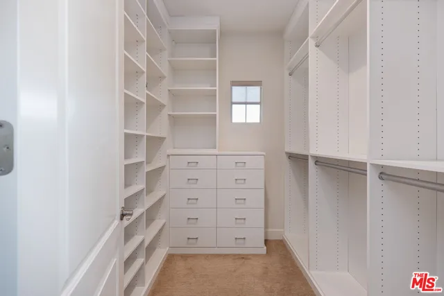 a front view of house with yard and trees in the background