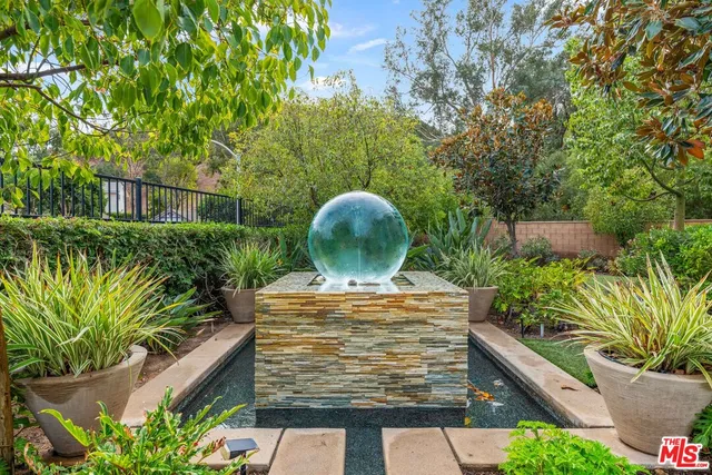 a view of a patio with table and chairs potted plants
