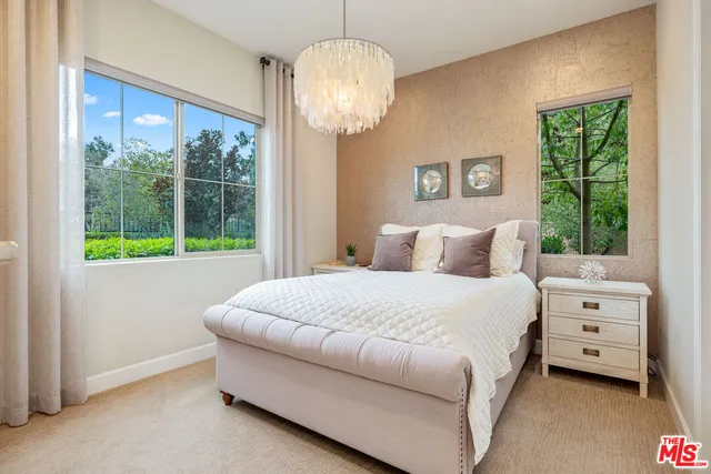 a living room with furniture and large windows
