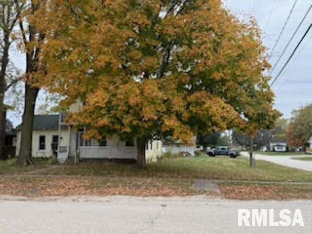 a view of a tree in front of a house