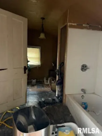 a bathroom with a tub sink and toilet