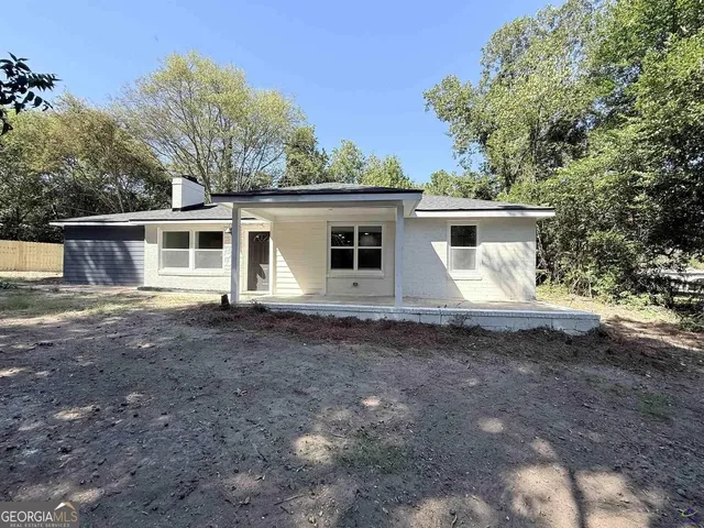 a view of a house with yard and a tree