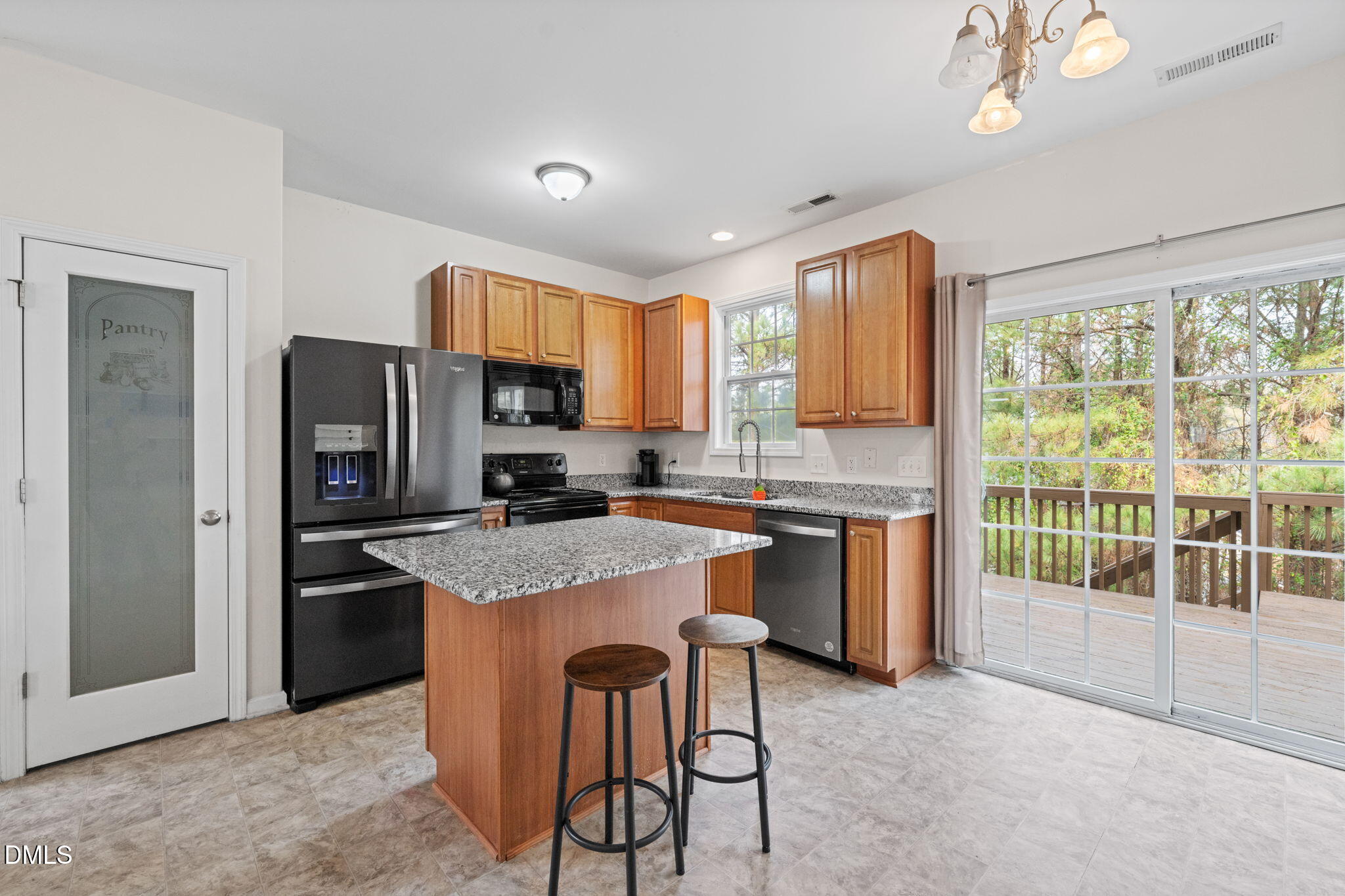5841 Wynmore Road Raleigh, NC 27610 - Photo 12 of 40 a kitchen with stainless steel appliances granite countertop a refrigerator a sink dishwasher a stove and a refrigerator with wooden floor