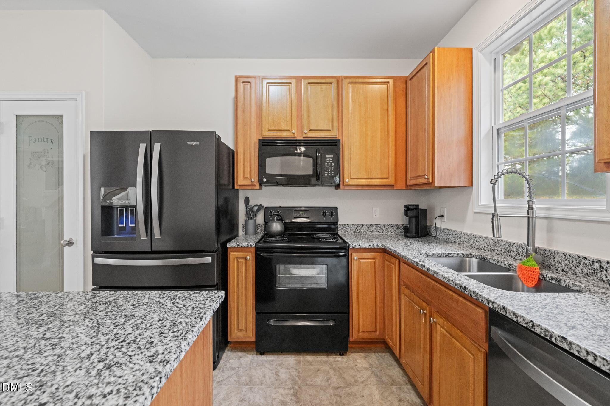 5841 Wynmore Road Raleigh, NC 27610 - Photo 14 of 40 a kitchen with stainless steel appliances granite countertop a stove a refrigerator and a sink