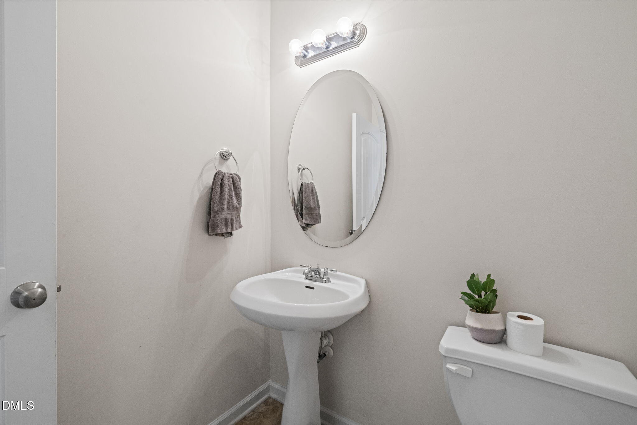 5841 Wynmore Road Raleigh, NC 27610 - Photo 17 of 40 a bathroom with a sink a mirror and a toilet