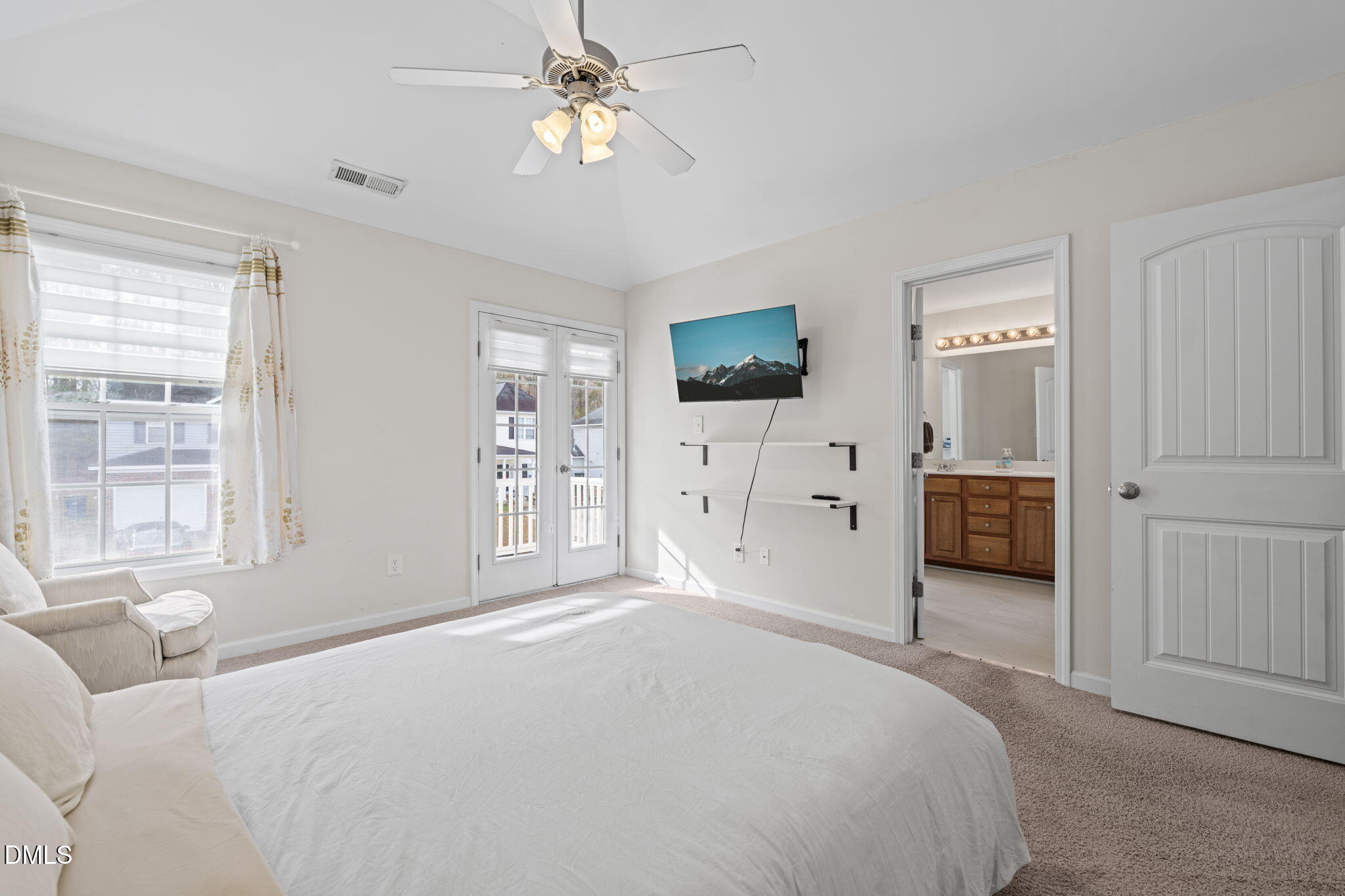 5841 Wynmore Road Raleigh, NC 27610 - Photo 20 of 40 a bedroom with a large bed and a flat tv screen on dresser