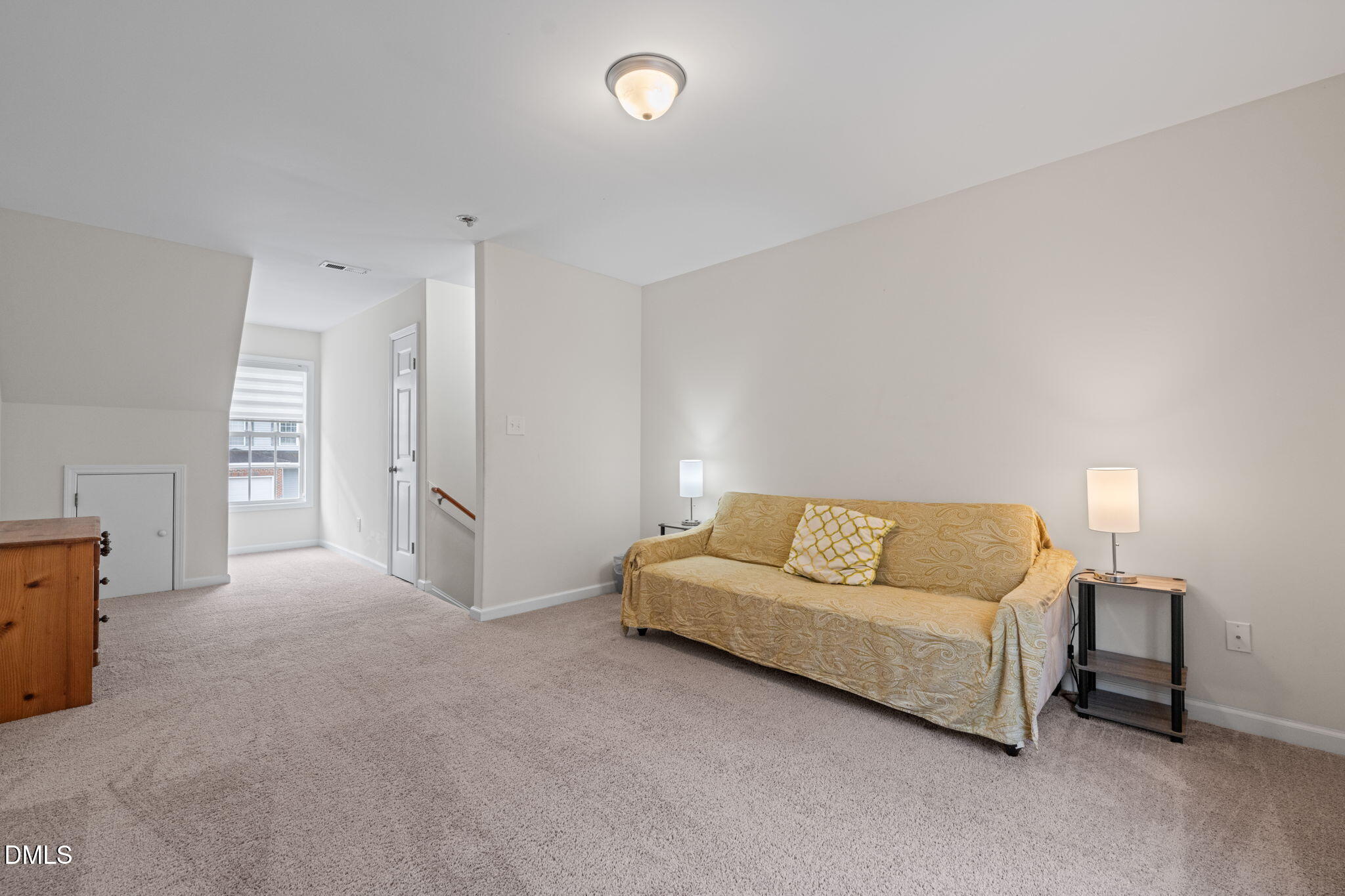 5841 Wynmore Road Raleigh, NC 27610 - Photo 31 of 40 a living room with furniture and a lamp
