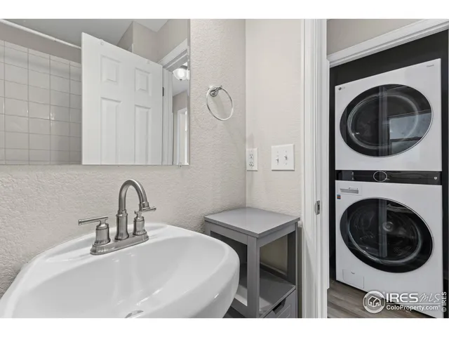 a bathroom with a sink a washer and dryer