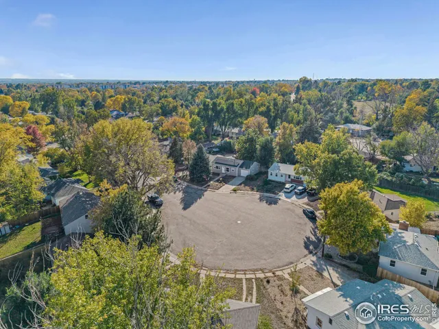 an aerial view of a house with a yard and lake view