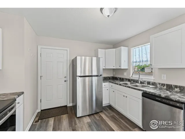 a kitchen with a sink a refrigerator and a stove