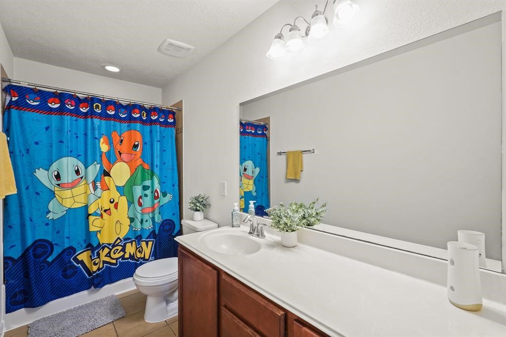 6719 Path Way Court Katy, TX 77449 - Photo 28 of 35 a bathroom with a sink mirror vanity and toilet