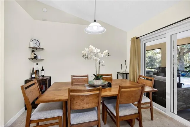a dining room with furniture a chandelier and window
