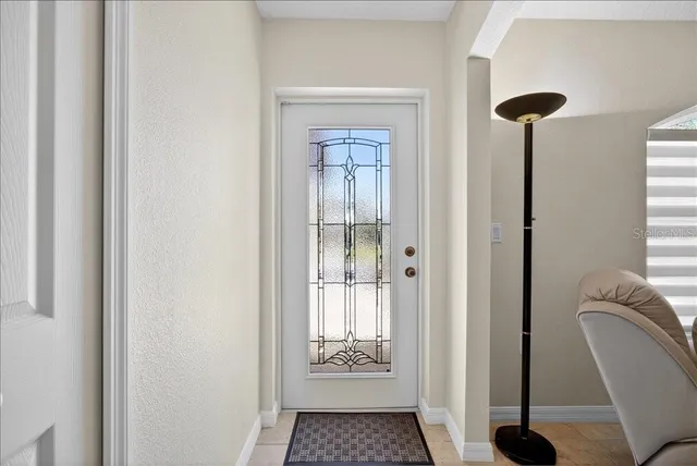 a view of a hallway with windows and closet