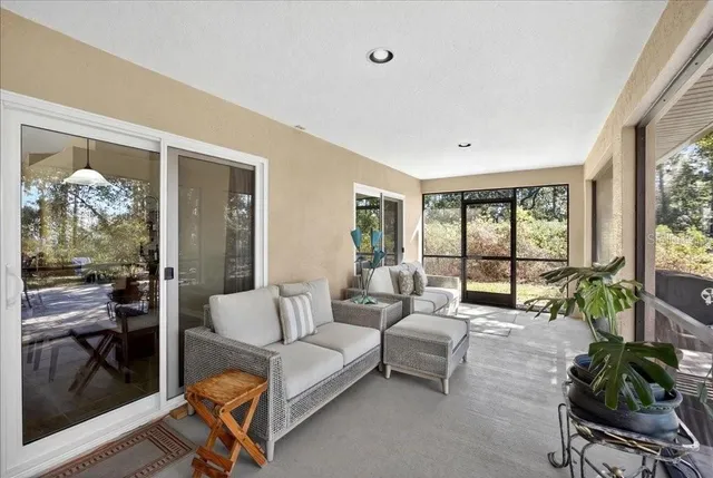 a living room with furniture and a floor to ceiling window