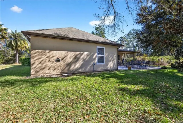 a front view of house with yard and outdoor seating