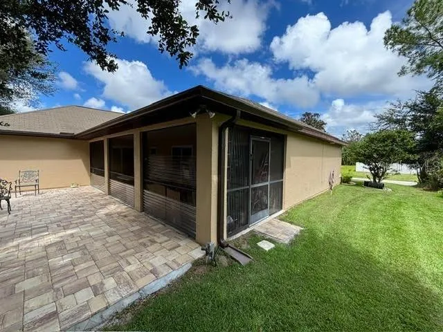 a view of backyard of house with green space