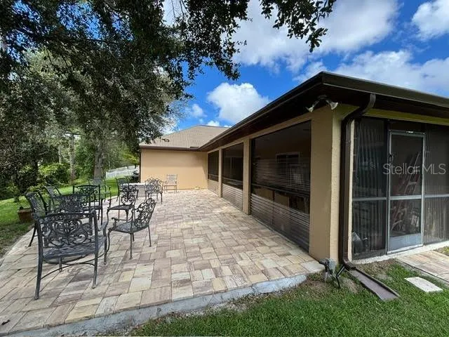 a view of house with backyard outdoor seating and green space