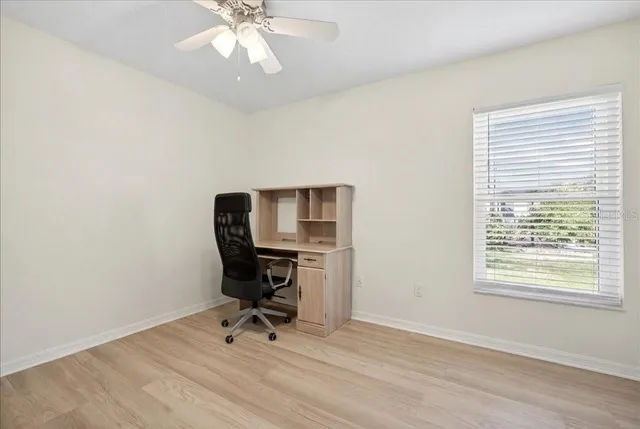 a view of workspace with wooden floor windows