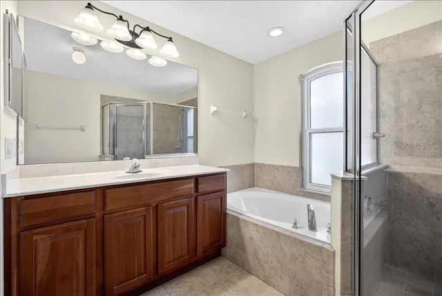 a spacious bathroom with a granite countertop sink a toilet and mirror