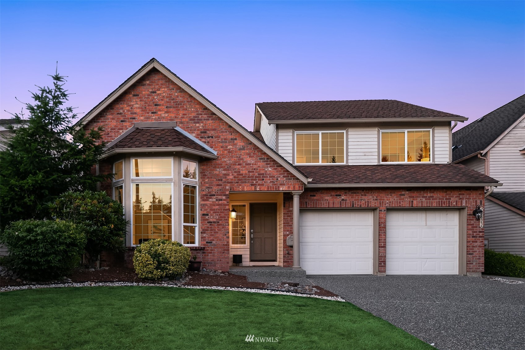 a front view of a house with a yard and garage