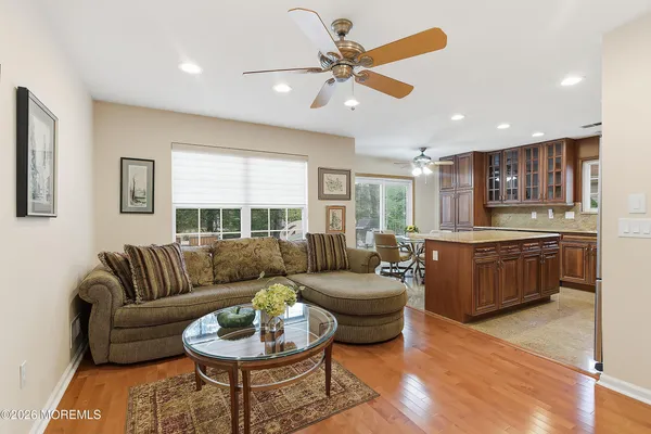 a living room with furniture and kitchen view