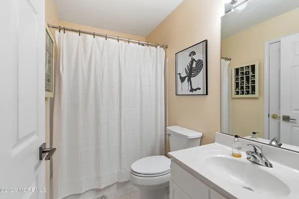a bathroom with a toilet a sink and a mirror